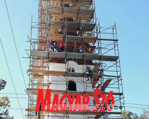 A megszentelt keresztet felhelyezik a felújítás alatt álló templomtoronyra (Tóth Péter felvétele)