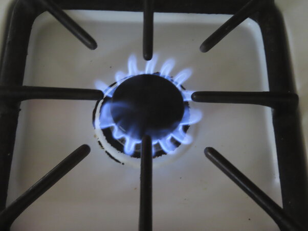 Natural gas burns on a kitchen stove in Atlantic City N.J., Thursday, July 26, 2023. Government pushes to move buildings and vehicles away from burning fossil fuels to help address climate c