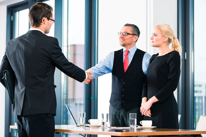 Business - young man in job interview for hiring, welcomes, Boss or Senior and his female Assistant in their office